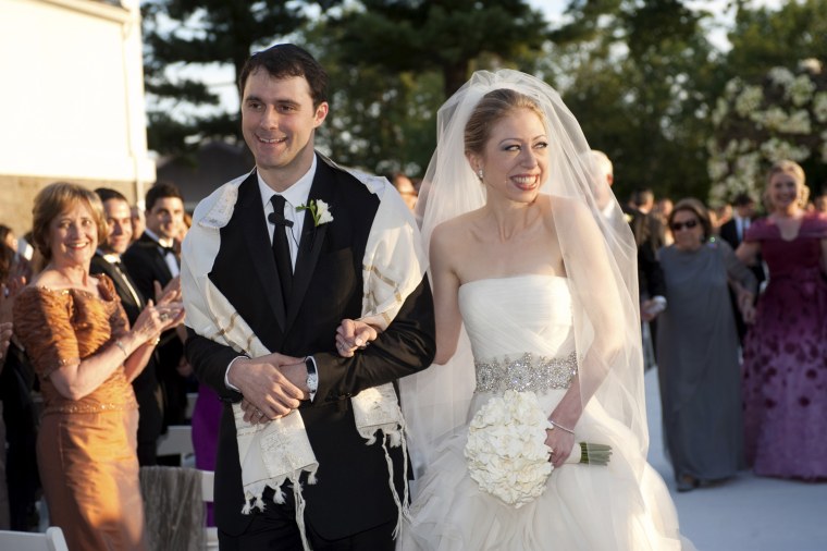 Image: Chelsea Clinton walks with Marc Mezvinsky after their wedding ceremony at Astor Court in Rhinebeck